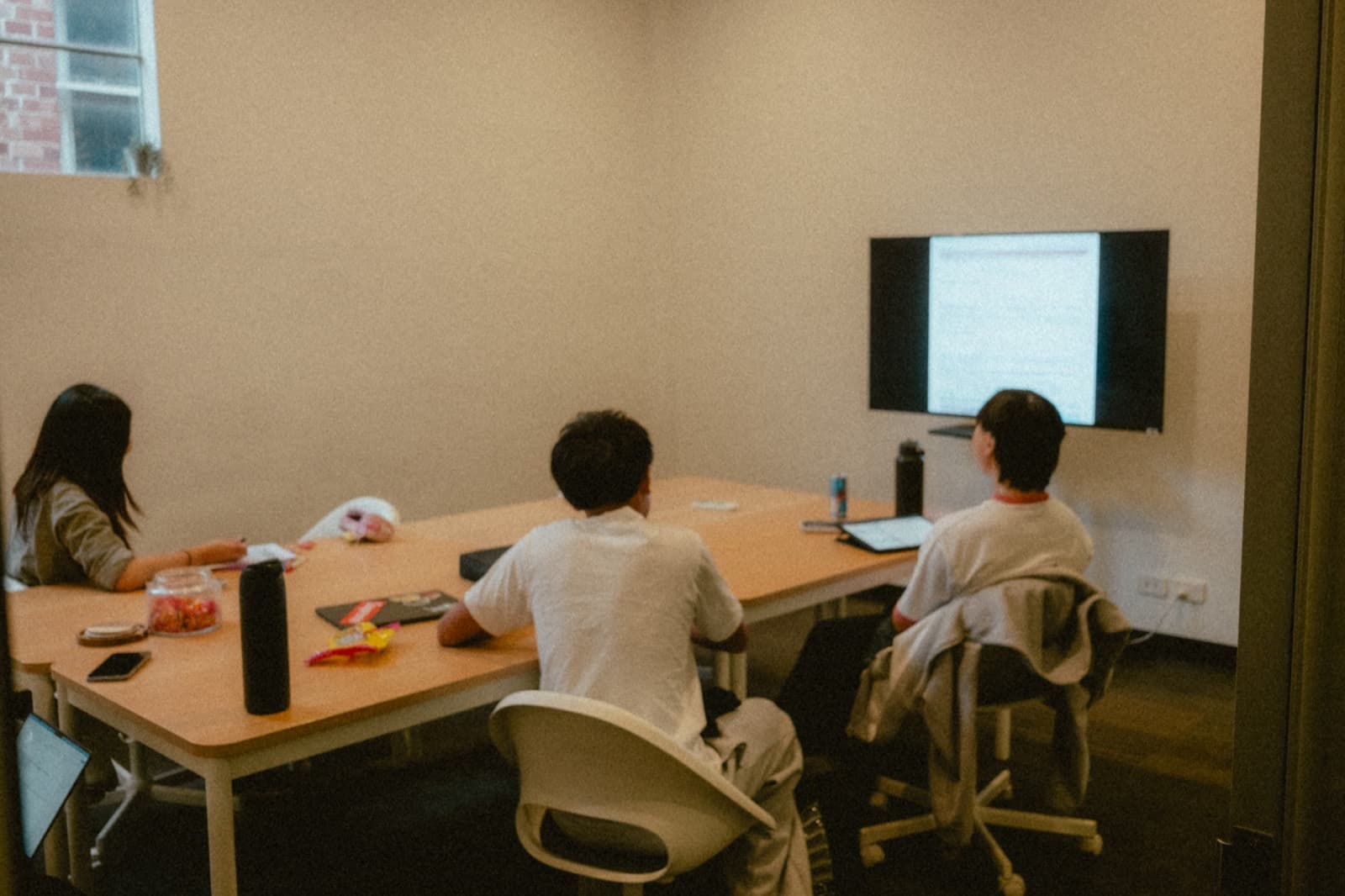 Students working together at a table in a tutoring session